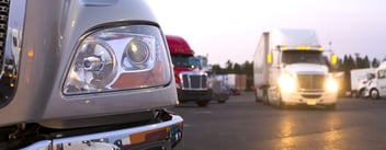 Semi-trucks parked in a row, symbolizing efficient logistics and transportation management